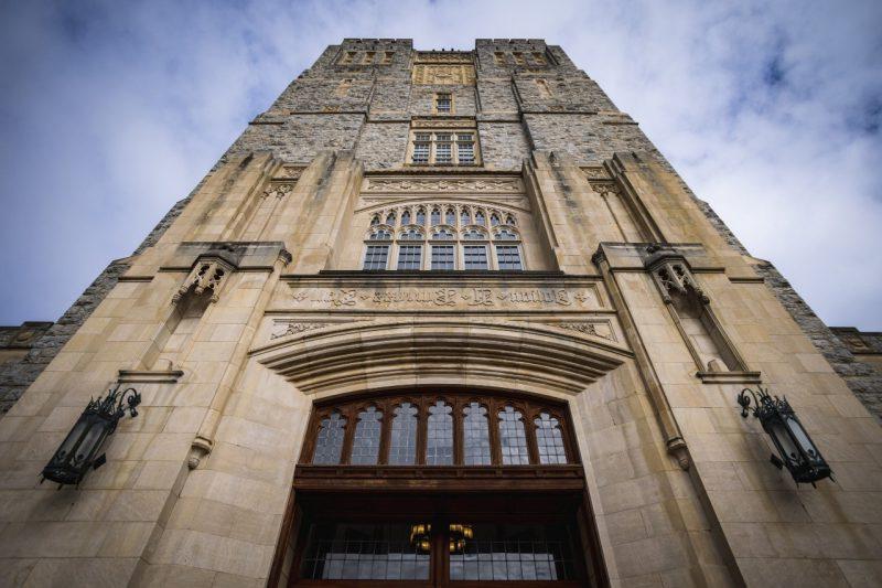 A photo looking straight up Burruss Hall tower into the blue sky.