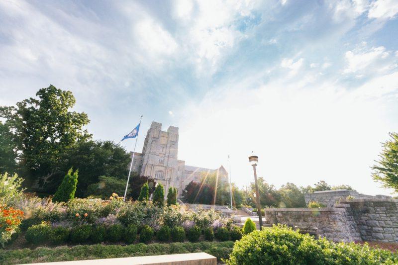 The sun shines behind Burruss Hall on a recent summer day.